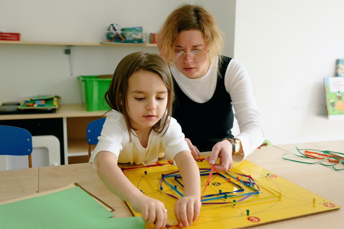 Free A Woman and a Girl Doing Artworks Stock Photo